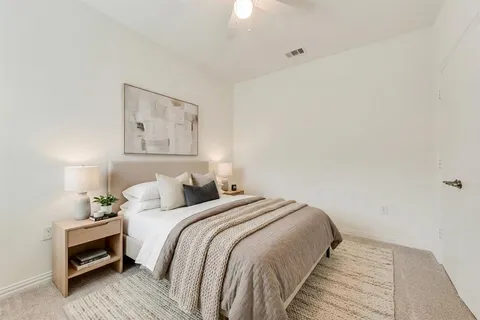 a bedroom with a bed and a painting on the wall