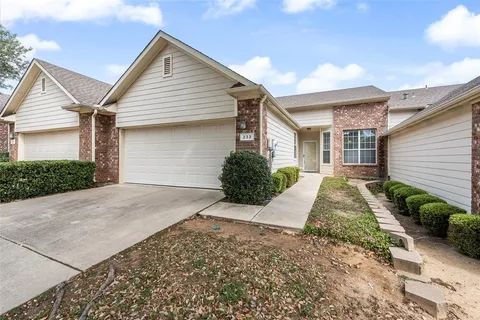 a view of a house with a yard and garage
