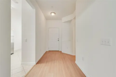 a view of a room with wooden floor