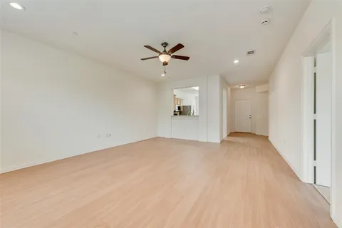 an empty room with fan and a ceiling fan