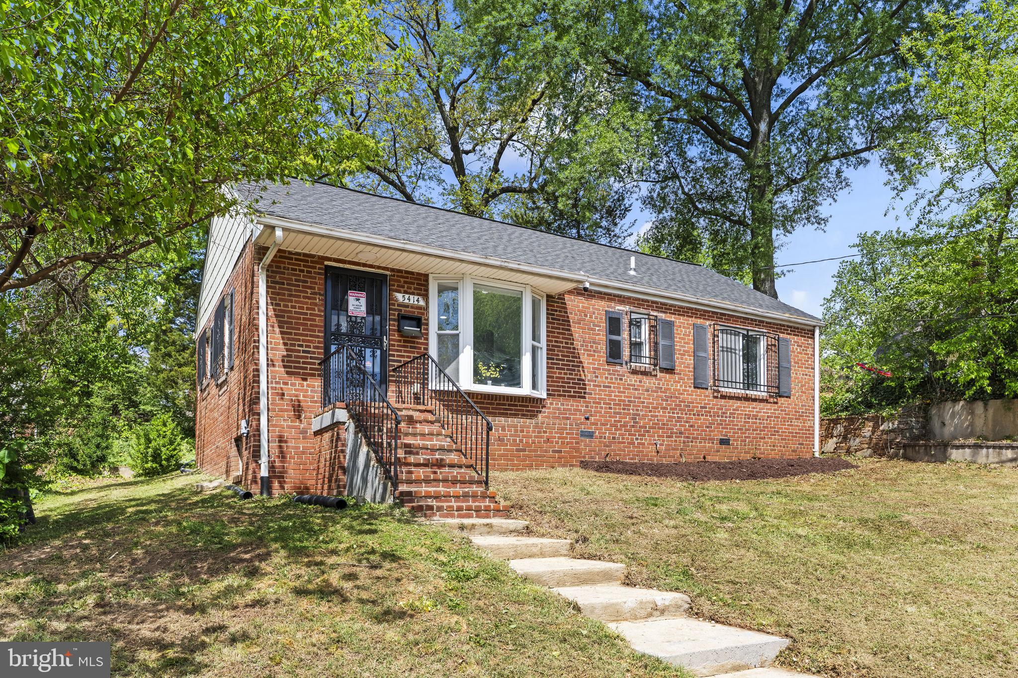 5414 Taussig Road Bladensburg, MD 20710 - Photo 2 of 26 Charming brick home with lush greenery.