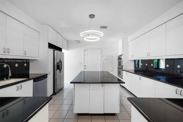 a kitchen with a sink and a stove top oven