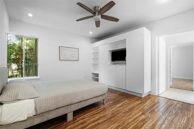 a bedroom with a large bed and a flat screen tv