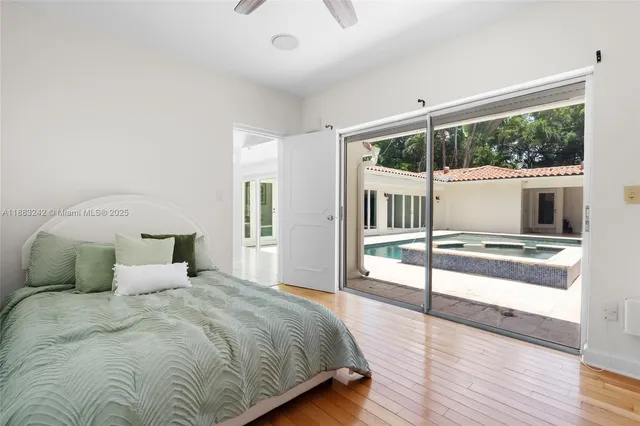 a bedroom with a large bed and a large window