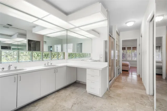 a large white kitchen with a large window
