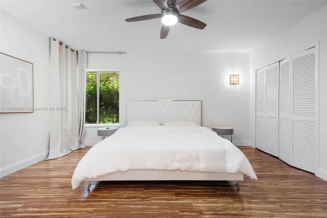 a large bed sitting in a bedroom next to a window