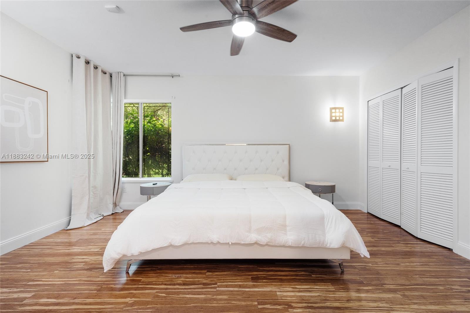 5810 Maggiore Street, Unit 5810 Coral Gables, FL 33146 - Photo 30 of 37 a large bed sitting in a bedroom next to a window