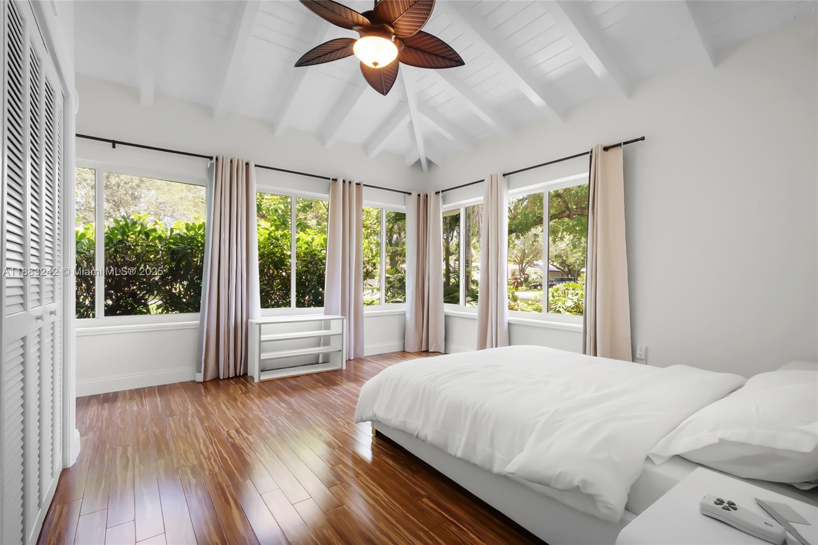 5810 Maggiore Street, Unit 5810 Coral Gables, FL 33146 - Photo 32 of 37 a spacious bedroom with a large bed and a large window