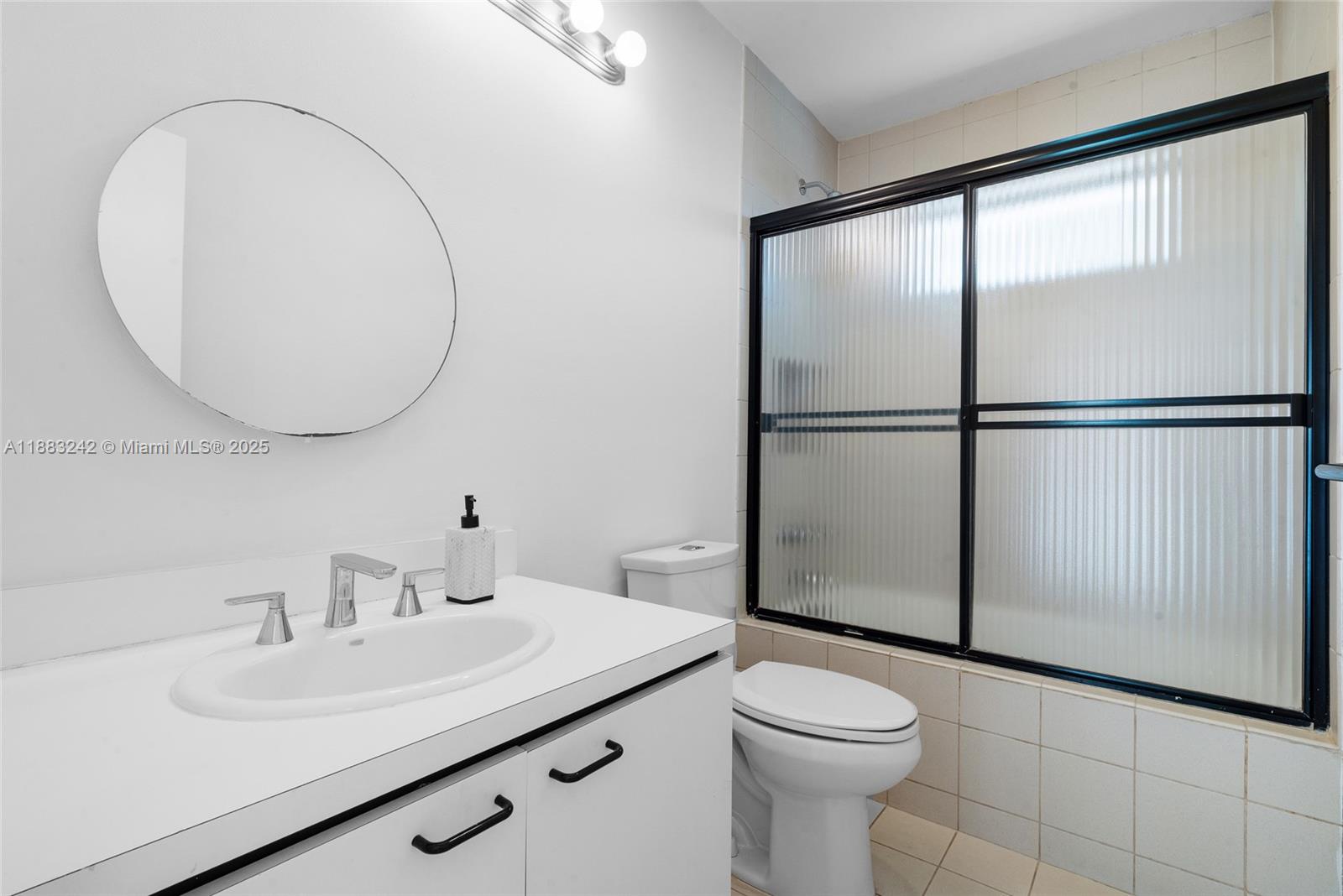 5810 Maggiore Street, Unit 5810 Coral Gables, FL 33146 - Photo 36 of 37 a bathroom with a sink toilet and a mirror