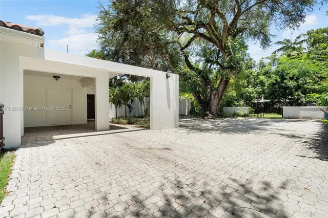 a view of a house with a snow on the road