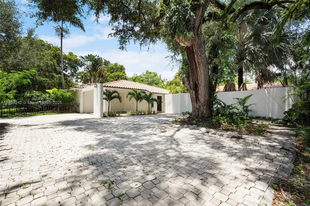 a front view of a house with a yard and a garage