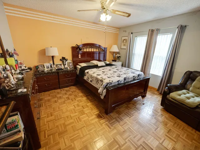 a bedroom with a bed dresser and a window