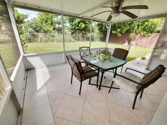 a view of a patio with furniture and a yard