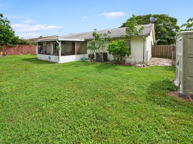 a view of a house with backyard and a garden