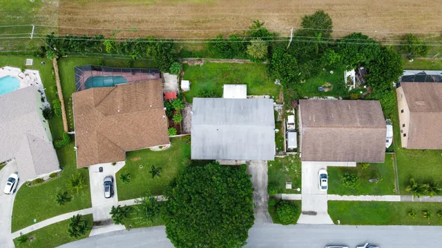 an aerial view of a house with a garden and lake view