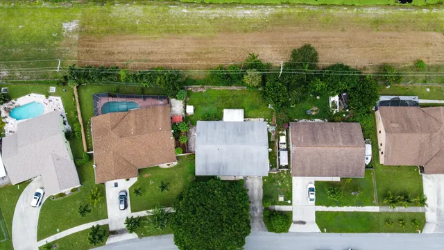 an aerial view of house with yard and lake view