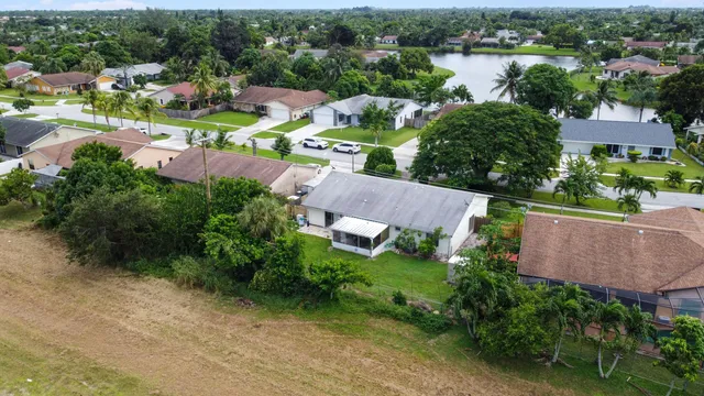 an aerial view of a house with garden space and lake view