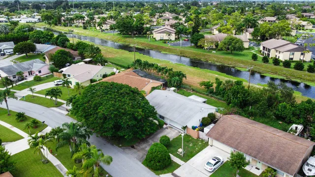 an aerial view of residential houses with outdoor space and street view