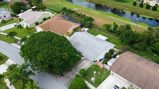 an aerial view of residential houses with outdoor space and street view
