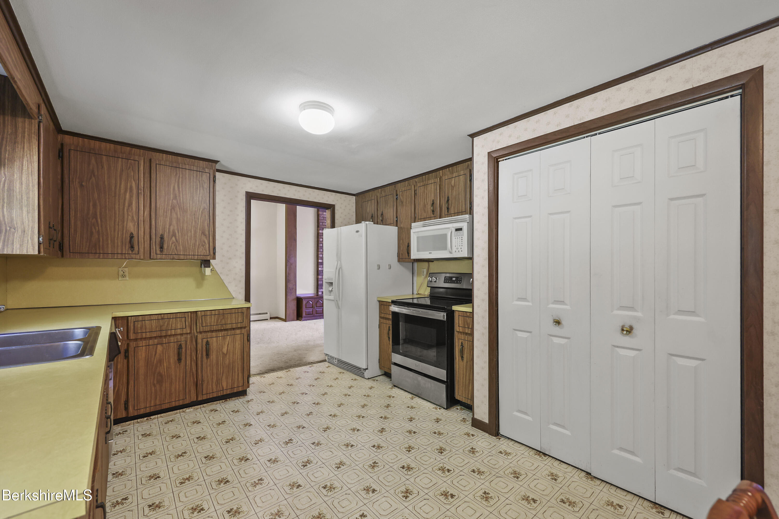 378 E Road Clarksburg, MA 01247 - Photo 12 of 36 a kitchen with a refrigerator and a stove top oven