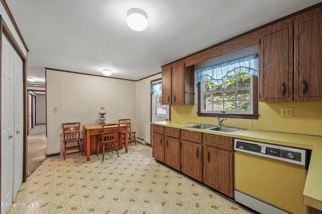 a kitchen with stainless steel appliances granite countertop a sink and cabinets