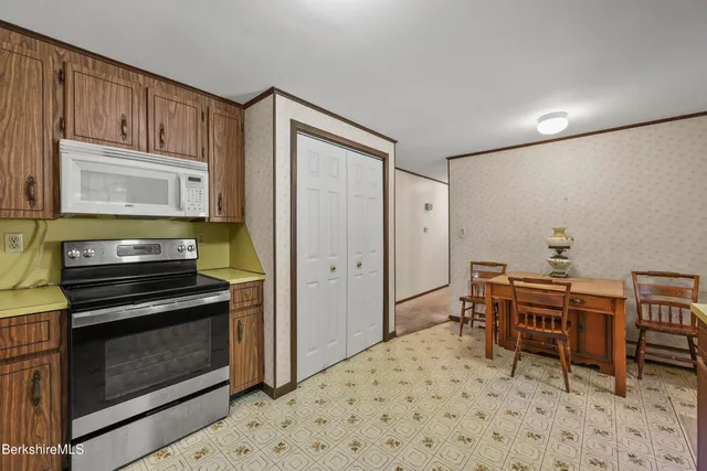 a kitchen with a stove and a refrigerator