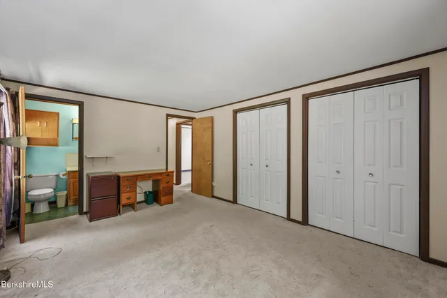 a view of empty room with furniture and a fireplace