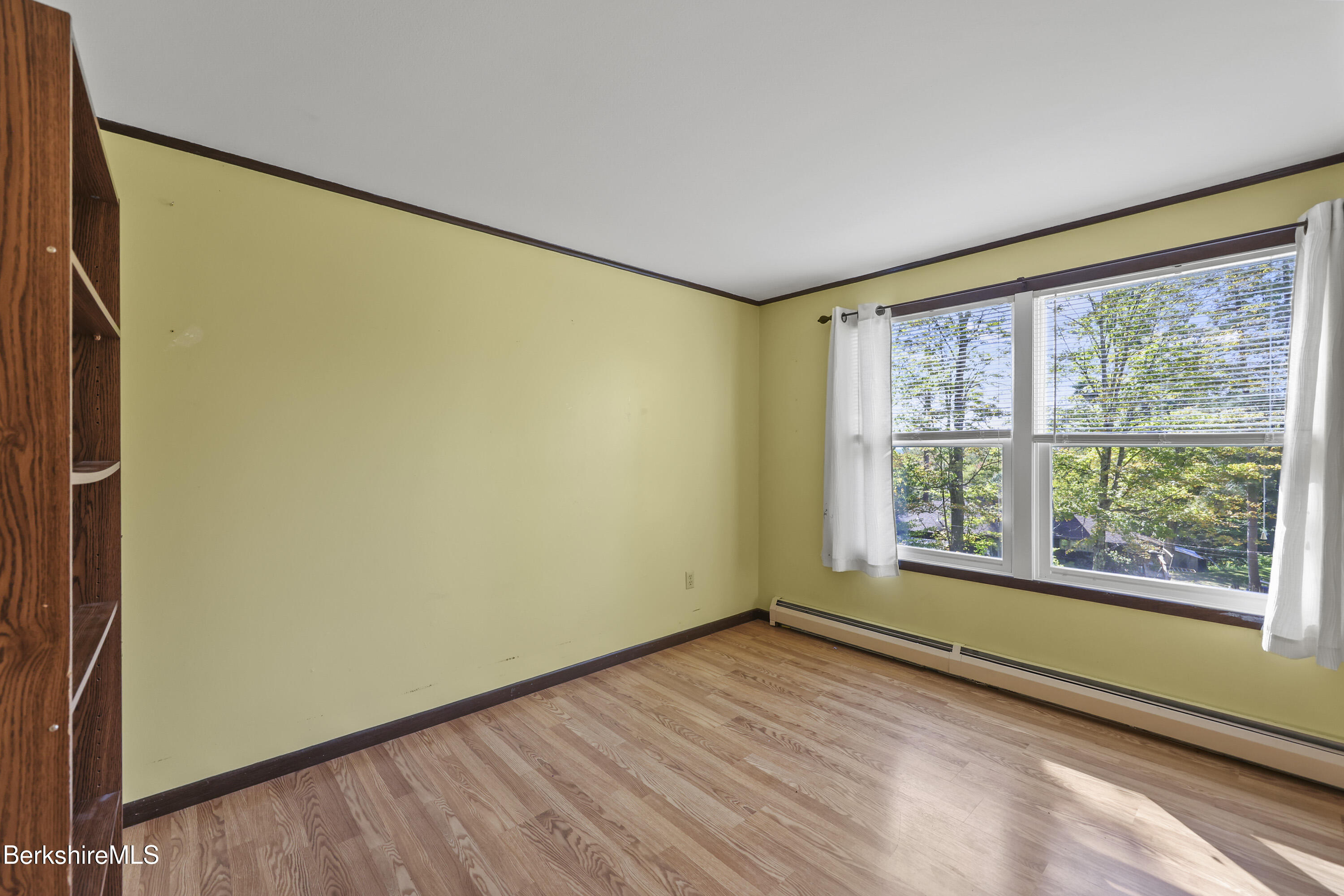 378 E Road Clarksburg, MA 01247 - Photo 21 of 36 a view of an empty room with a window and wooden floor