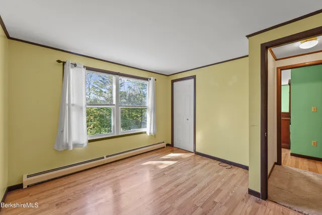 a view of an empty room with glass door and a window