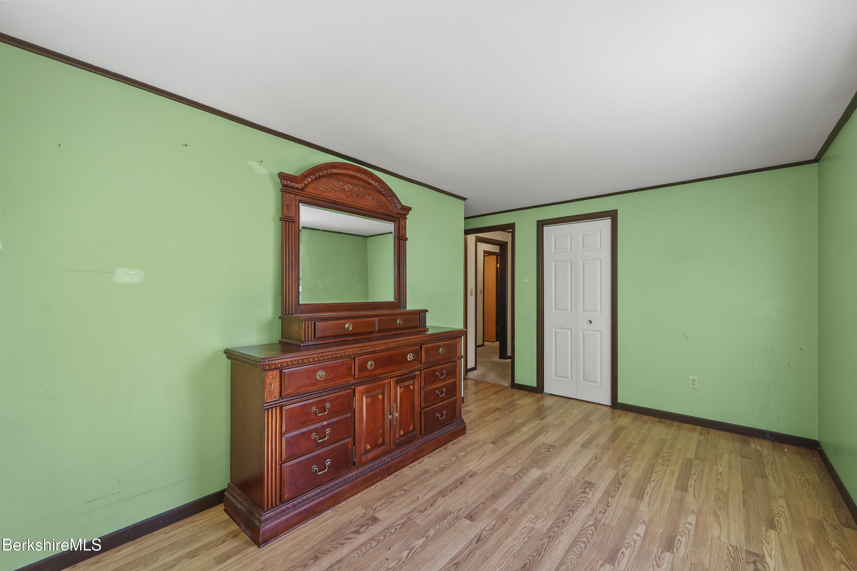 378 E Road Clarksburg, MA 01247 - Photo 26 of 36 a room with a dresser and a wooden floor
