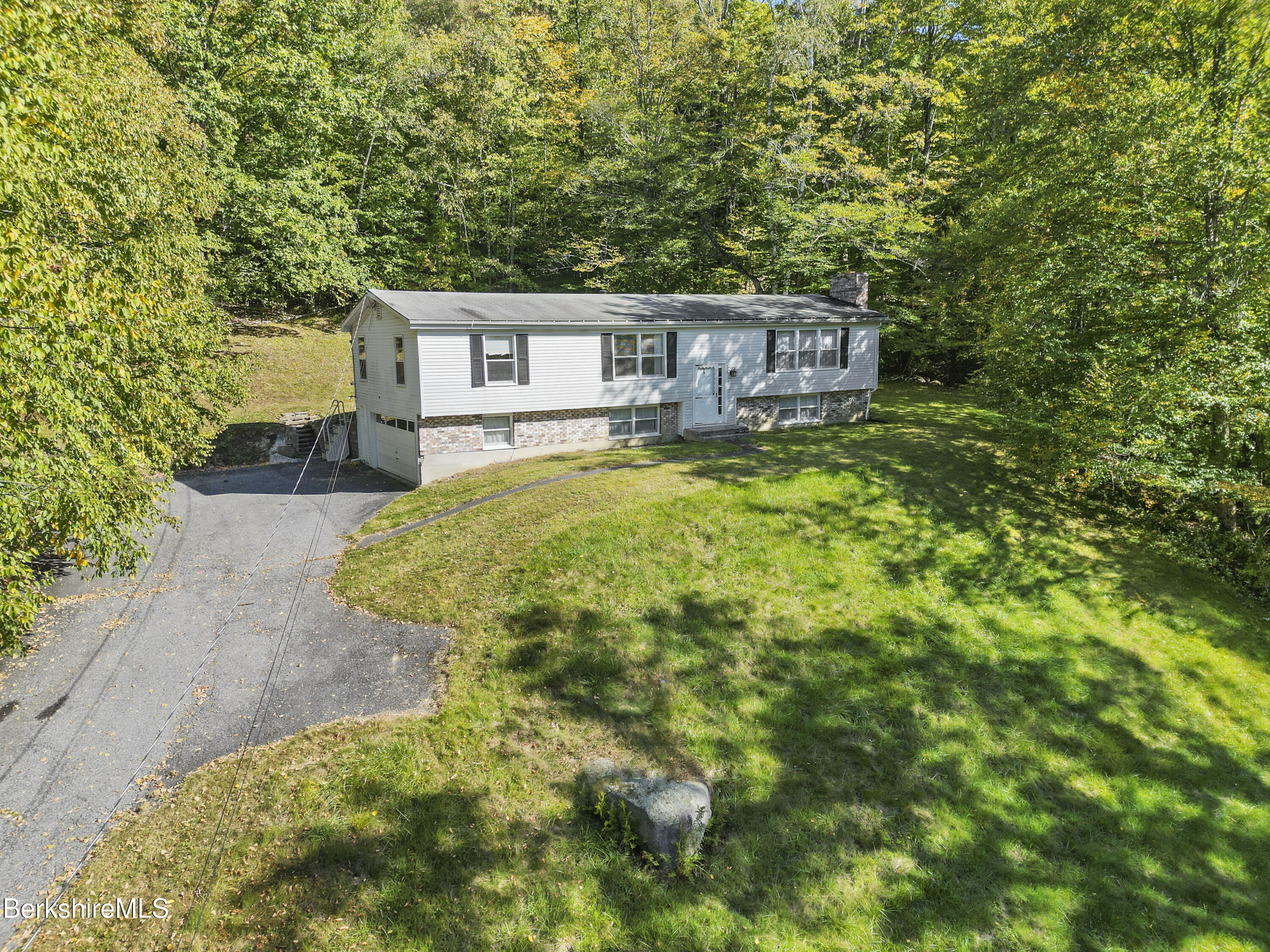378 E Road Clarksburg, MA 01247 - Photo 34 of 36 a front view of a house with a yard and trees
