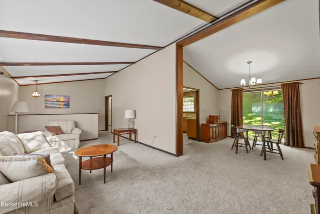 a living room with furniture a ceiling fan and a window