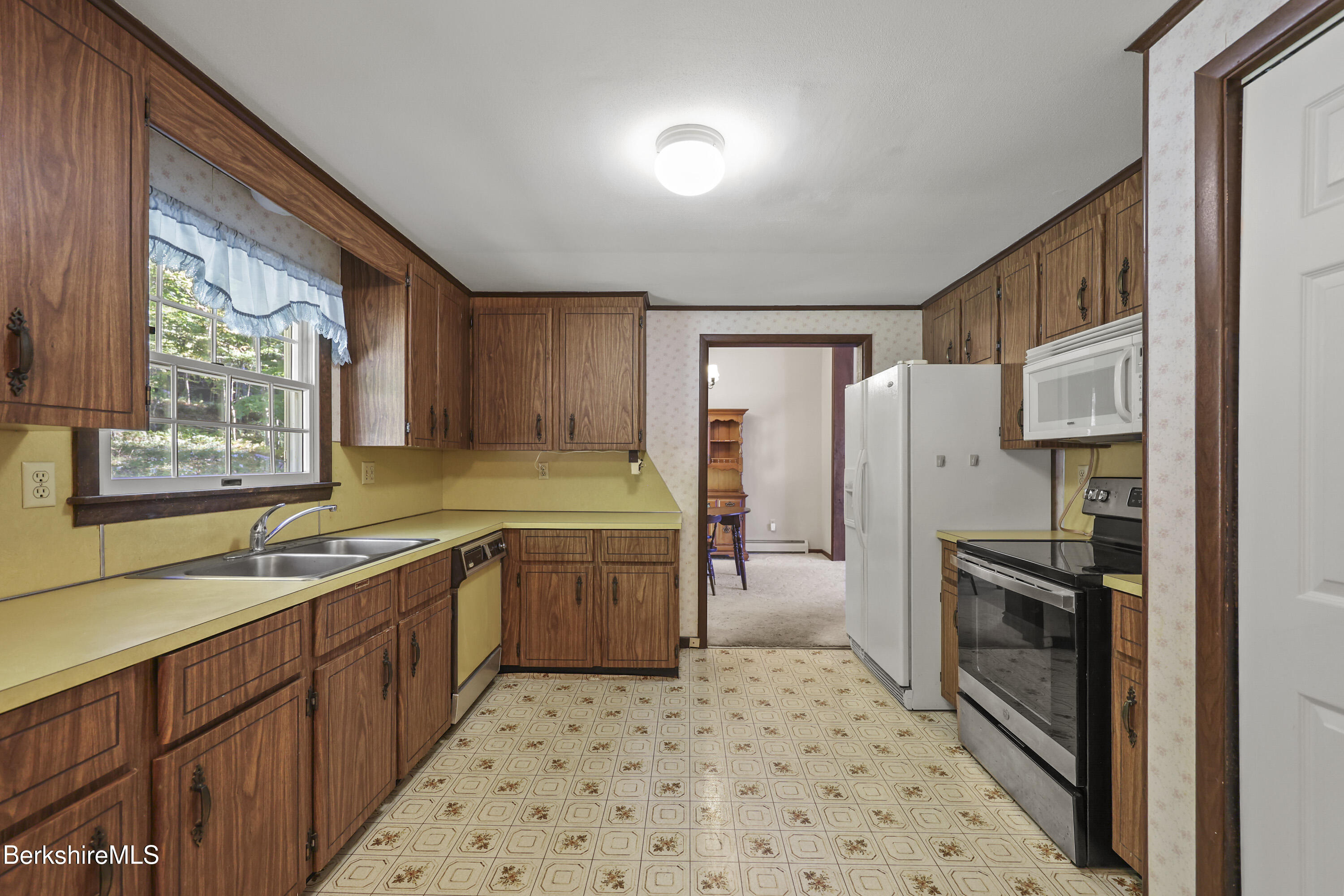 378 E Road Clarksburg, MA 01247 - Photo 10 of 36 a kitchen with granite countertop a refrigerator and a sink