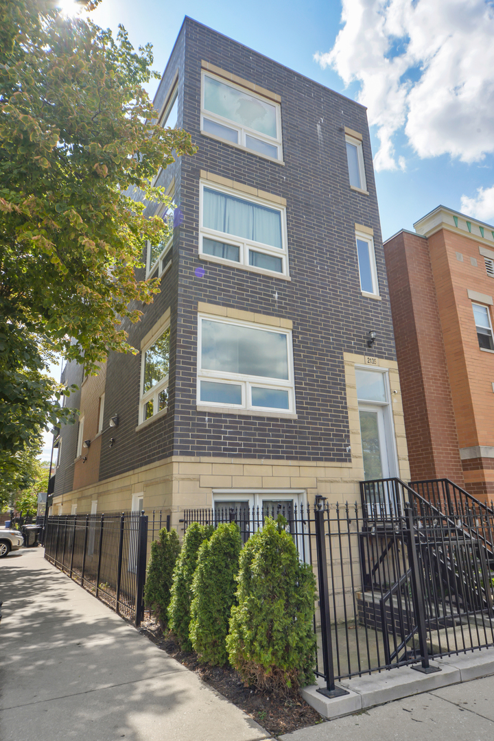 2135 West Adams Street, Unit 4 Chicago, IL 60612 - Photo 1 of 16 front view of a brick house with a small yard