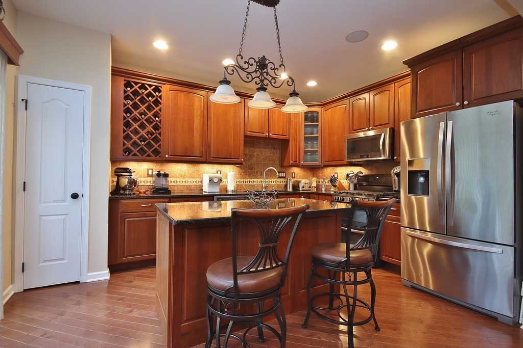 1118 Cold Spring Road Fishkill, NY 12524 - Photo 12 of 34 a kitchen with refrigerator a sink and chairs