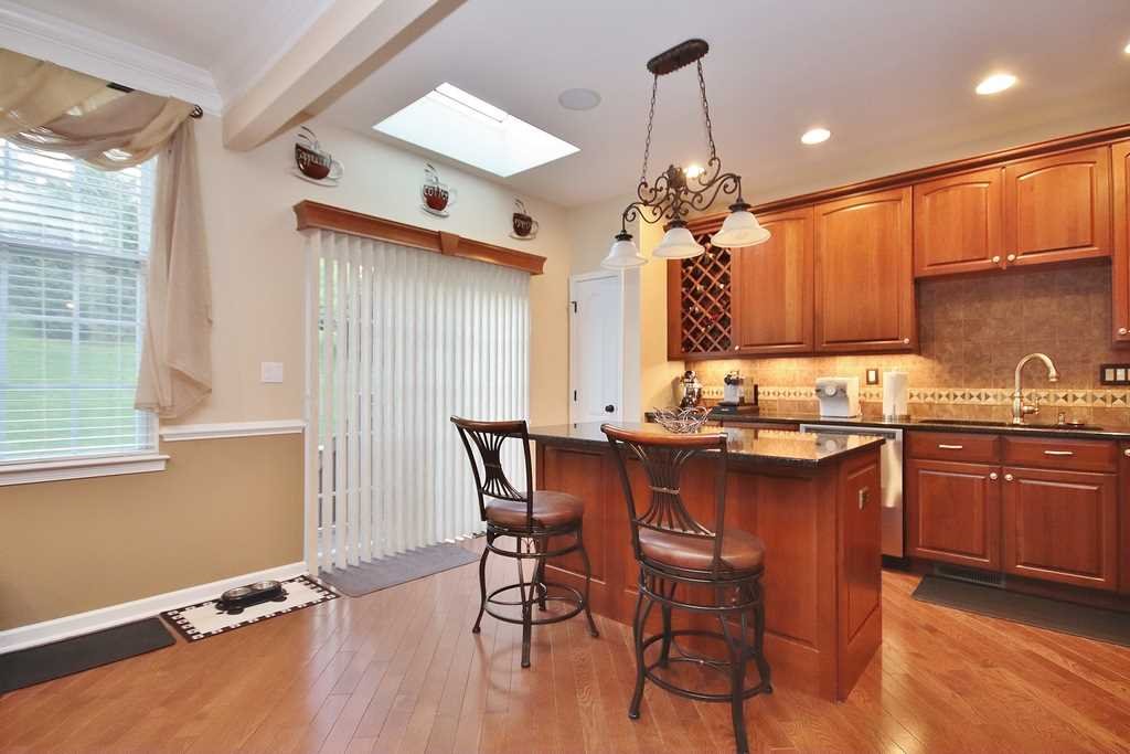 1118 Cold Spring Road Fishkill, NY 12524 - Photo 13 of 34 a kitchen with a table chairs sink and cabinets