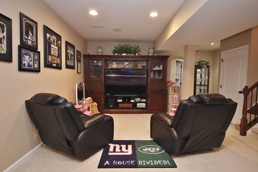 1118 Cold Spring Road Fishkill, NY 12524 - Photo 19 of 34 a living room with furniture a flat screen tv and a fireplace