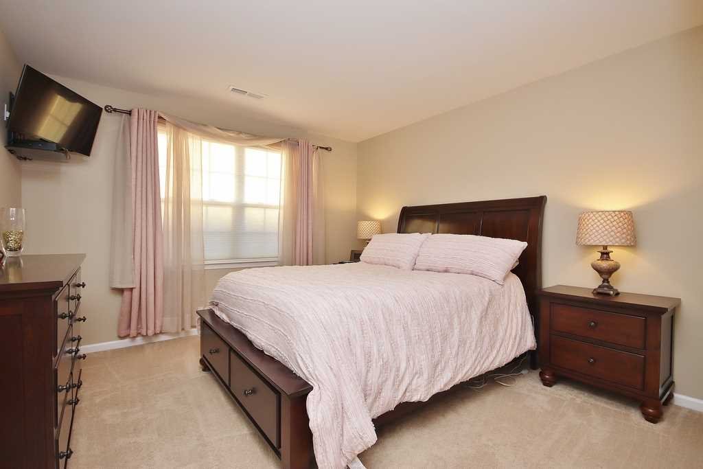 1118 Cold Spring Road Fishkill, NY 12524 - Photo 28 of 34 a bedroom with a bed and a flat tv screen on a dresser