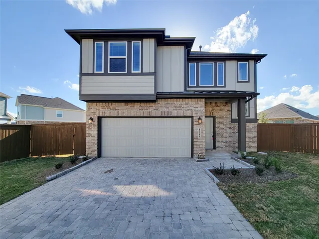 a front view of a house with yard and parking space