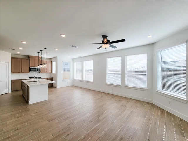 a view of kitchen with sink and wooden floor