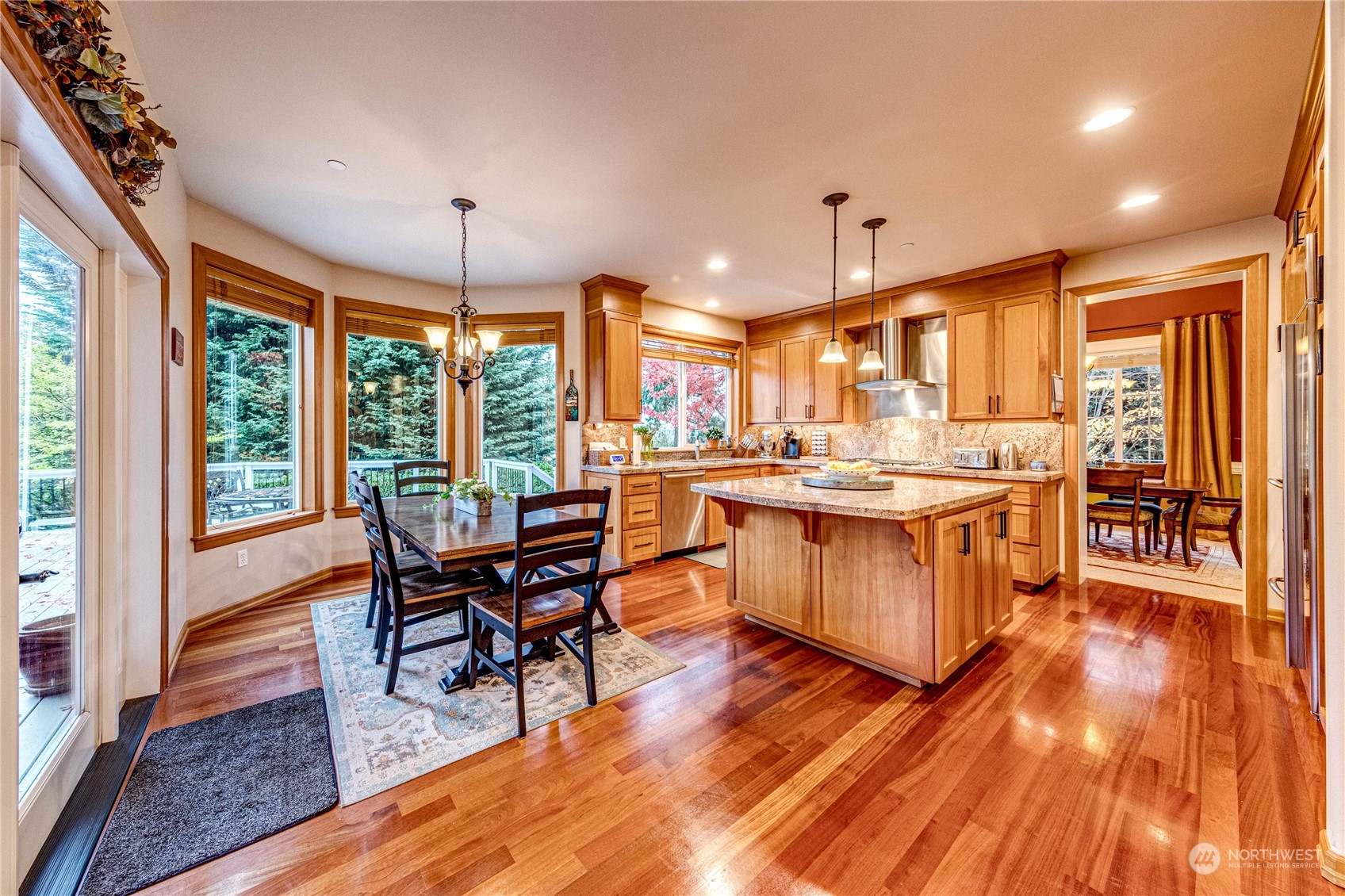 18928 108th Avenue Northeast Bothell, WA 98011 - Photo 11 of 39 a kitchen with a table chairs wooden floors and a view of living room