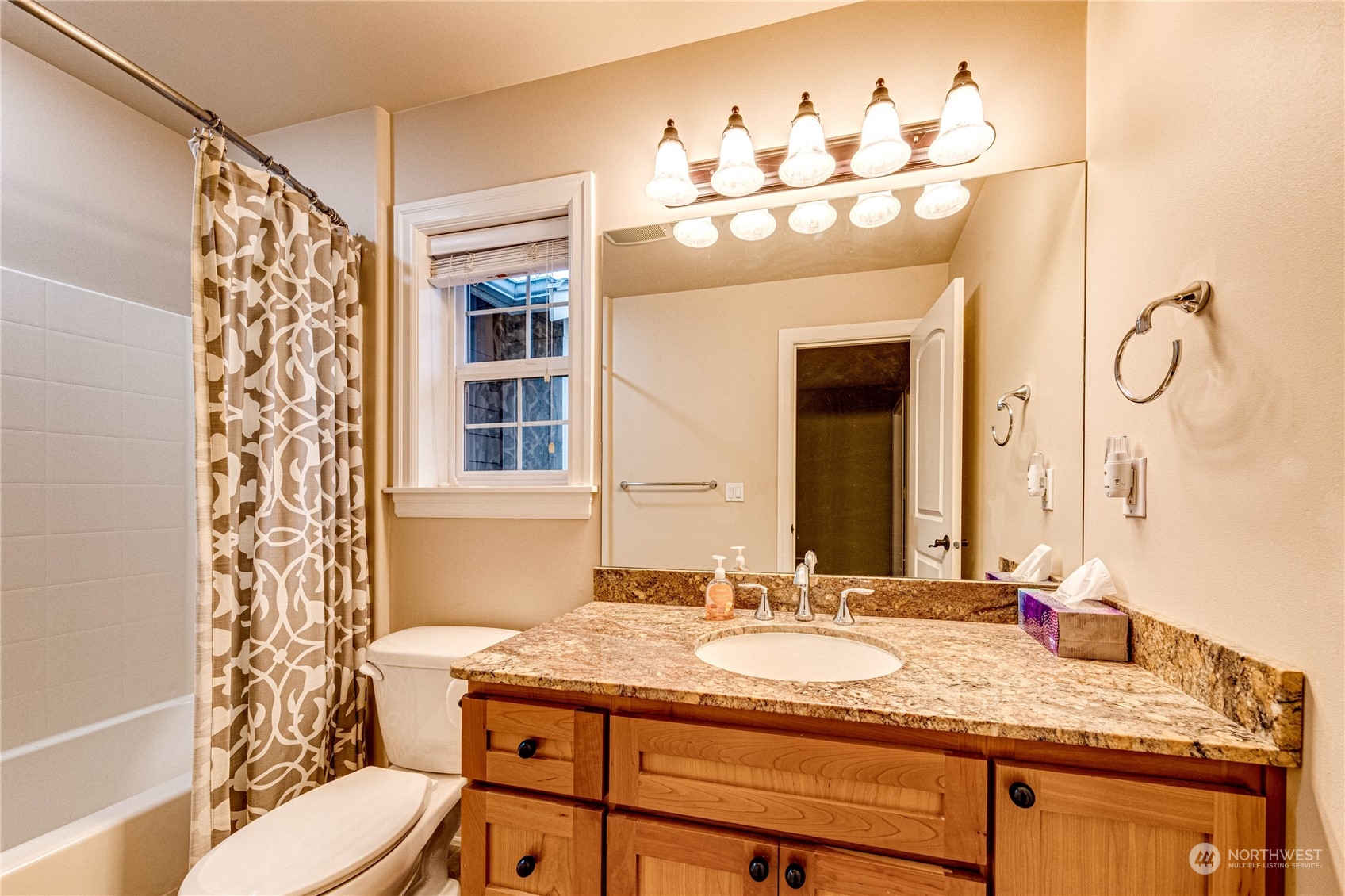 18928 108th Avenue Northeast Bothell, WA 98011 - Photo 22 of 39 a bathroom with a granite countertop sink a mirror and a shower