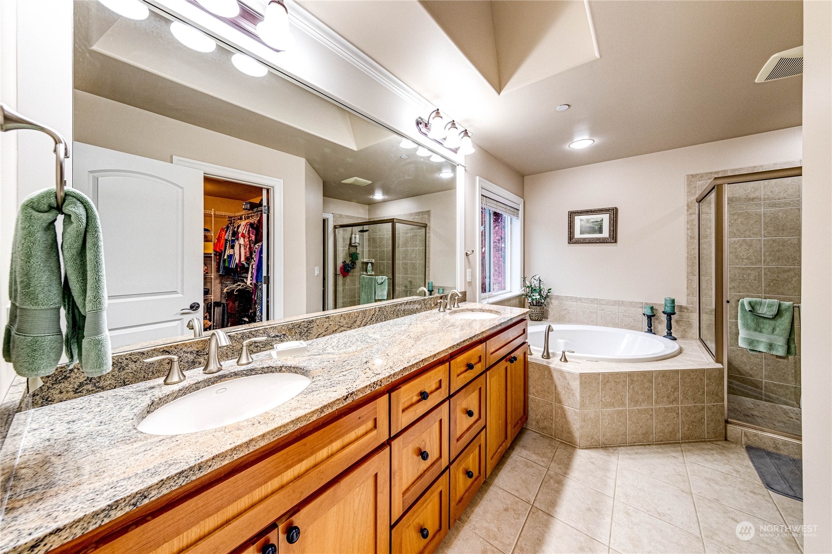 18928 108th Avenue Northeast Bothell, WA 98011 - Photo 25 of 39 a spacious bathroom with a sink double vanity granite tub shower and a mirror