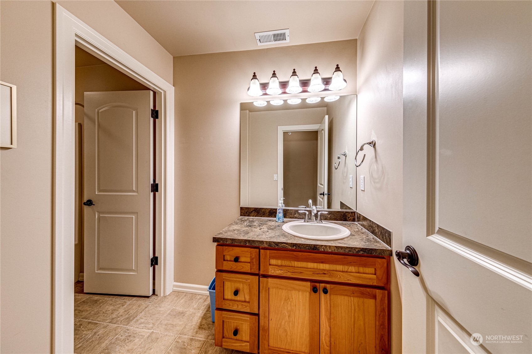 18928 108th Avenue Northeast Bothell, WA 98011 - Photo 32 of 39 a bathroom with a sink and a mirror