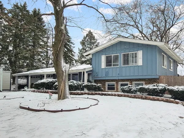 a view of house with a yard covered in snow