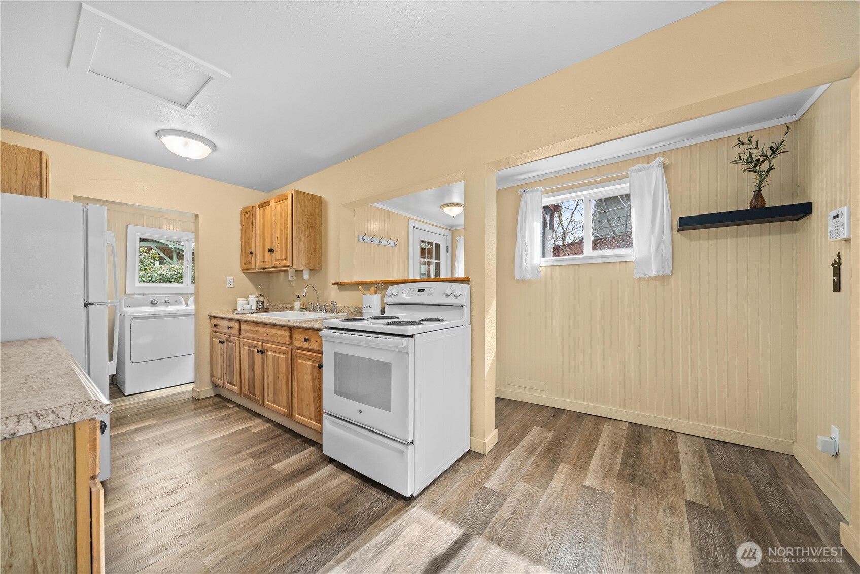 23711 Dorre Don Way Southeast Maple Valley, WA 98038 - Photo 12 of 40 a kitchen with granite countertop white cabinets and white appliances