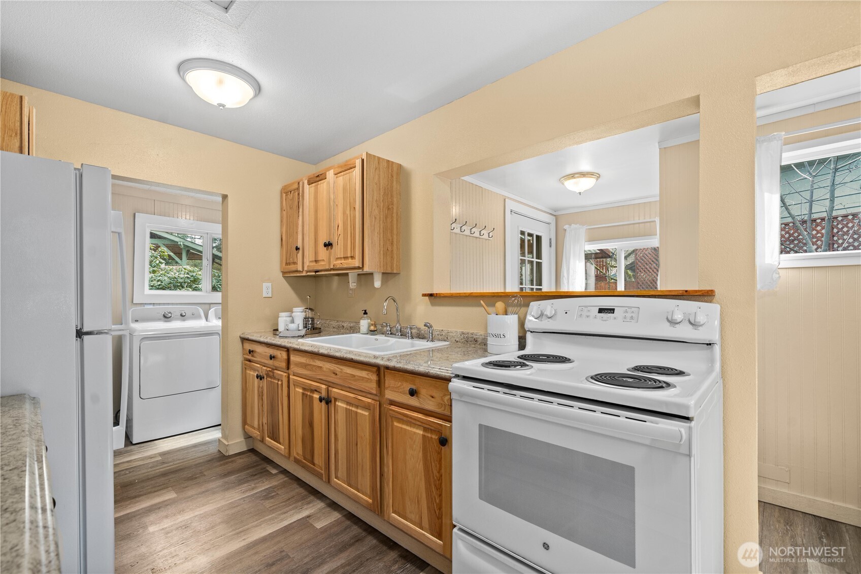 23711 Dorre Don Way Southeast Maple Valley, WA 98038 - Photo 14 of 40 a kitchen with stainless steel appliances a stove sink and cabinets