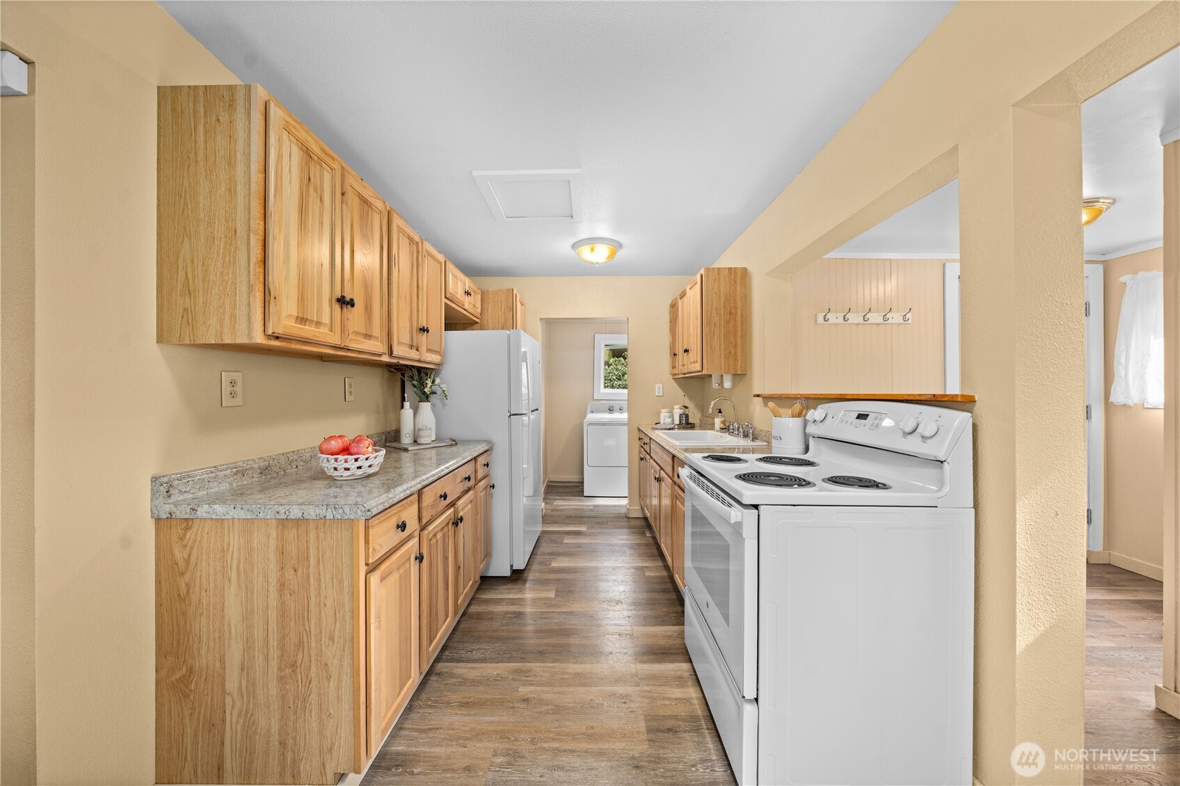23711 Dorre Don Way Southeast Maple Valley, WA 98038 - Photo 15 of 40 a kitchen with a stove top oven sink and cabinets