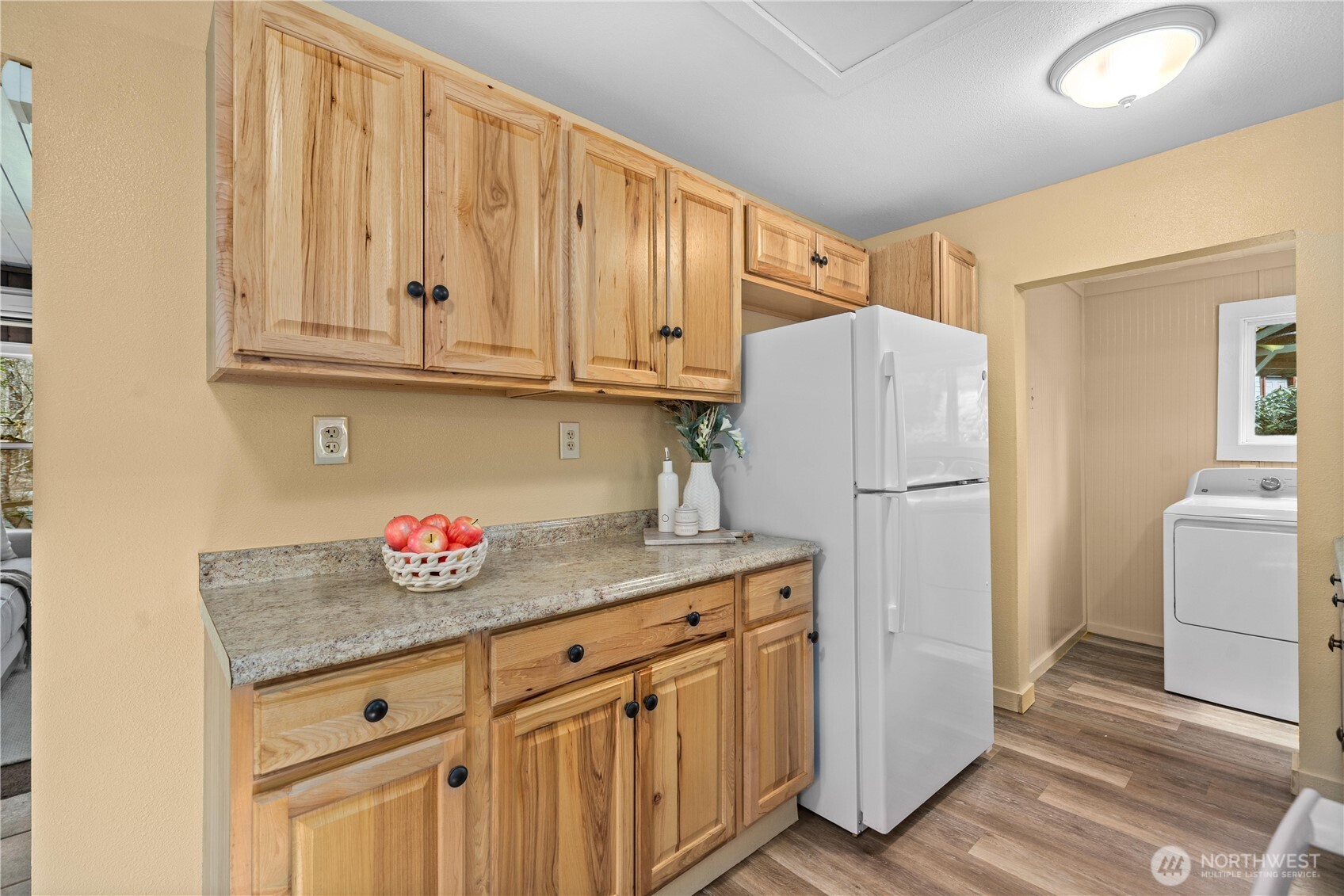 23711 Dorre Don Way Southeast Maple Valley, WA 98038 - Photo 16 of 40 a kitchen with granite countertop a refrigerator sink and cabinets