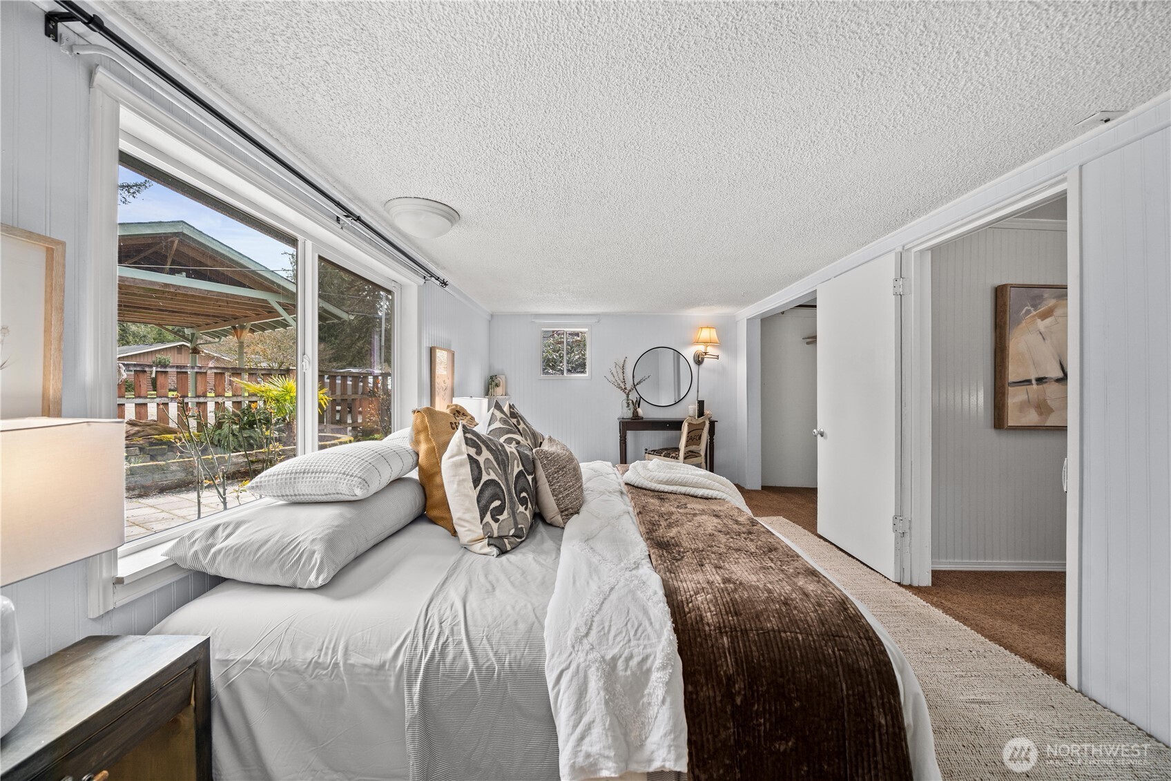 23711 Dorre Don Way Southeast Maple Valley, WA 98038 - Photo 20 of 40 a bedroom with a large bed and a large window